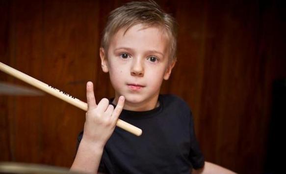 A child with a drum stick