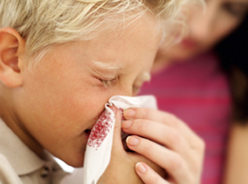 Boy Blowing His Nose into a Handkerchief