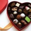 a heart-shaped chocolate box with chocolate in it